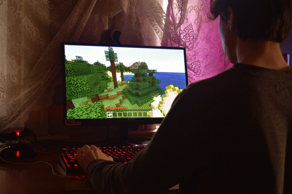 A boy playing a video game on a flat screen TV.