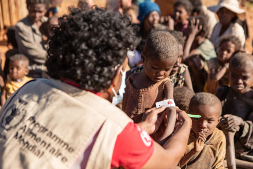 An aid worker measures the arm of a 4-year-old child in an area suffering from a lack of food due to a long-term drought in southern Madagascar.