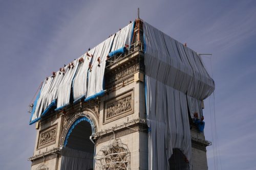 Fabric panels are being unfurled in front of the outer walls of the Arc de Triomphe, Paris, September 12, 2021