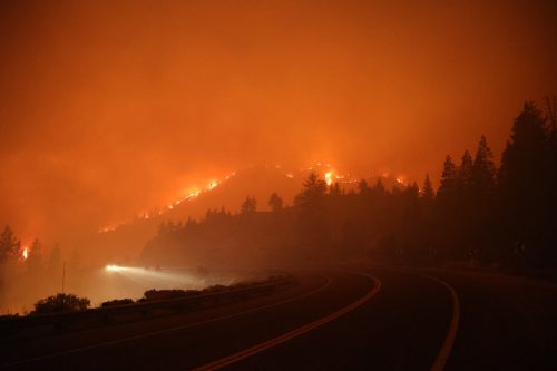 A mountain ridge is outlined in flames that are part of the Caldor Fire on August 29, 2021.