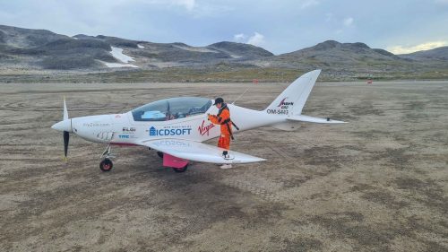 Zara Rutherford in front of her plane on an airfield in Kulusuk, Greenland.