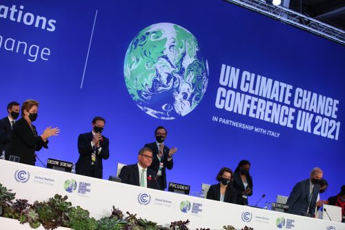 COP26 Closing Plenary. People clap after the Glasgow Climate Pact is approved.