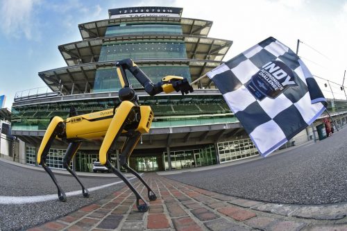 Indy Autonomous Challenge: Spot, the robot dog built by the Boston Dynamics company, waves the starting flag.