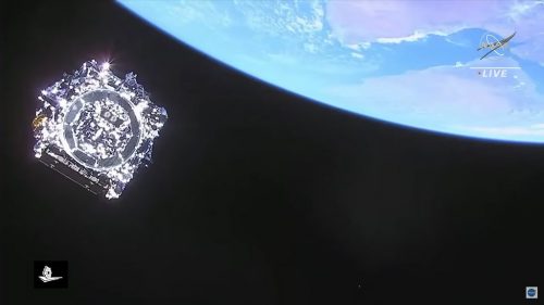 Final look at the James Webb Space Telescope as it heads into deep space. Webb will soon begin an approximately two-week process to deploy its antennas, mirrors, and sunshield. This image was captured by the cameras on board the rocket’s upper stage as the telescope separated from it. The Earth hovers in the upper right.