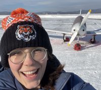 Zara Rutherford in front of her plane on a snow-covered runway on January 18, 2022, two days before she completed her trip around the world.