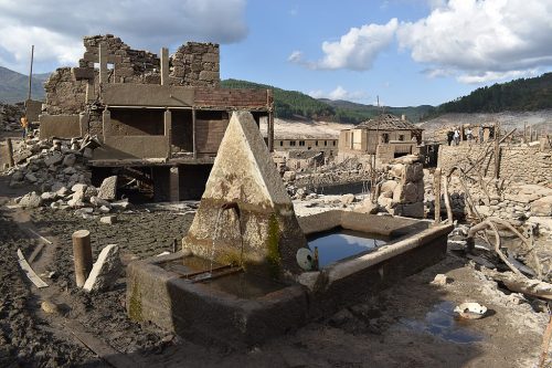 View of a fountain still functioning in the flooded village of Aceredo