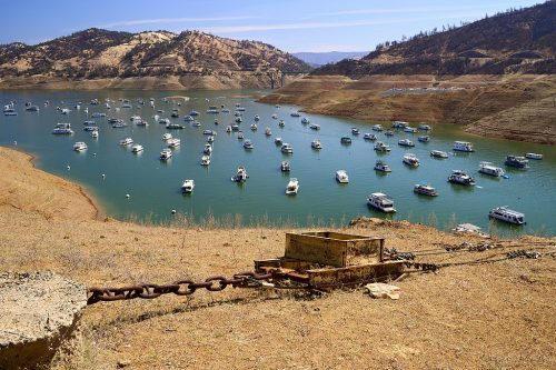 Lake Oroville on the morning of Memorial Day 2021. In May 2021, water levels of Lake Oroville dropped to 38% of capacity. The boats are dwarfed by the exposed banks while California is headed into another drought year.