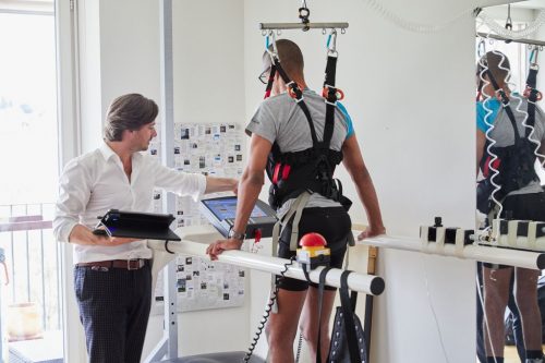 Grégoire Courtine, one of the scientists behind the breakthrough, advises a patient who is supported and on a treadmill.