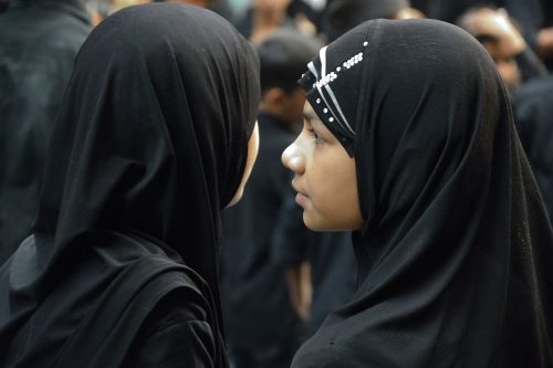 Two Muslim girls in hijabs, photographed during the Mourning of Muharram in Kolkata.