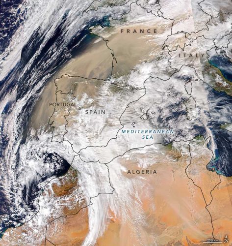 A satellite view showing clouds of dust blowing north and west from northern Africa across Spain and into France.