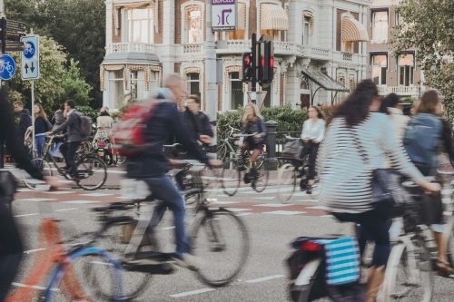 A street in Amsterdam busy with cyclists.