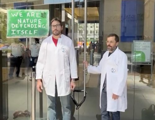 Dr. Peter Kalmus speaks while chained to the JPMorgan Chase bank building during a Scientists Rebellion protest.