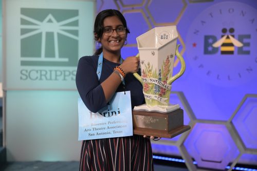 Harini Logan holding her winner's cup from the Scripps National Spelling Bee