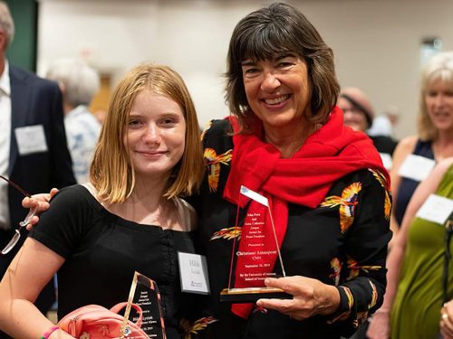 Hilde Lysiak, 12, and CNN's Christiane Amanpour. Each is holding the Zenger award they won.