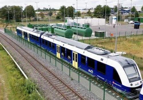 Hydrogen-powered train stopped at a hydrogen refueling station.