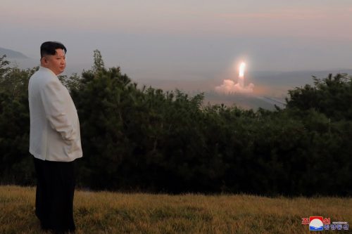 Kim Jong Un watches a missile taking off.