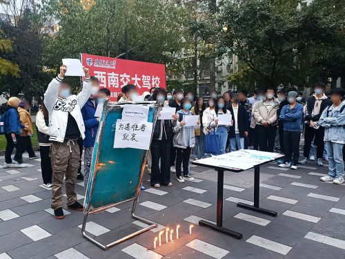 Some students at Southwest Jiaotong University lit candles to mourn the victims of the Urumqi fire and held up white paper in protest.