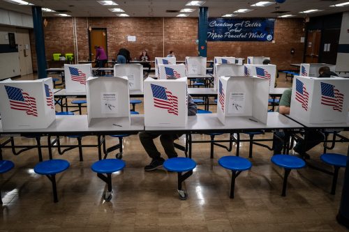 People voting at a school in Des Moines that's serving as polling location in the 2022 election.