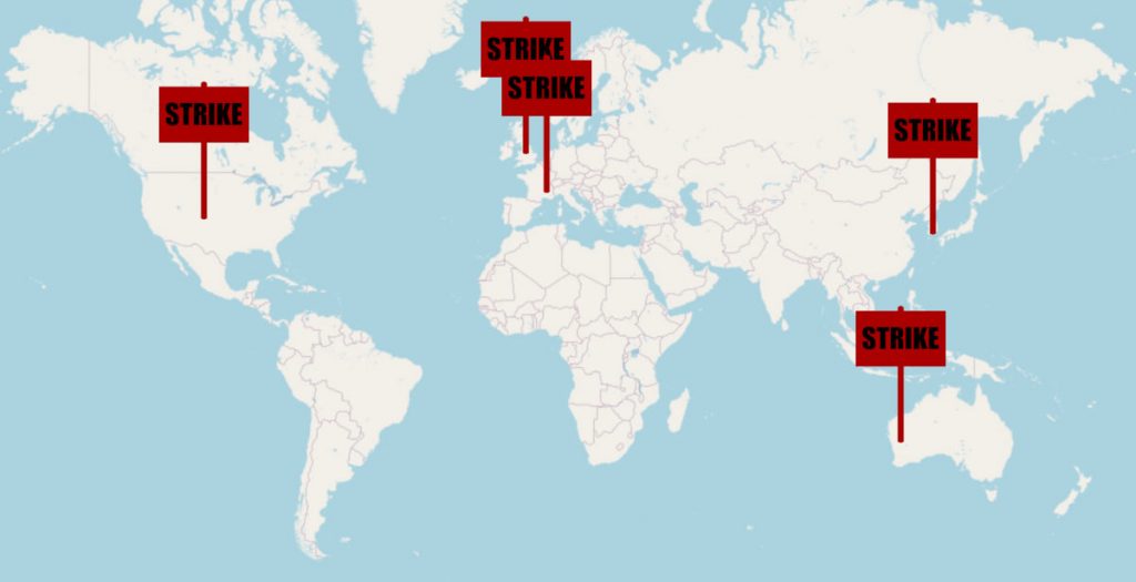 Map of the world, with red protest signs marking locations where there are currently strikes.