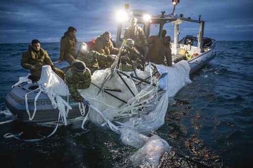 Sailors in a boat recover tangled remnants of a Chinese high-altitude surveillance balloon off the coast of Myrtle Beach, South Carolina, Feb. 5, 2023.