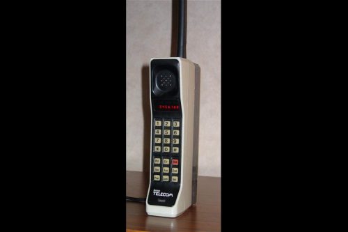 A Motorola DynaTAC 8000X from 1984. This phone has an early British Telecom badge and primitive red LED display.