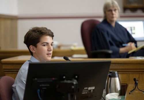 Youth plaintiff Mica testifies in court while Judge Seeley listens.