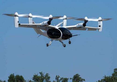 Joby Aviation's aircraft in the air above trees.