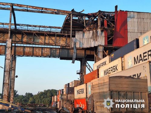 A metal building above shipping containers is destroyed. Port infrastructure on the Danube in the Odesa region of Ukraine after a Russian drone attack on the night of 24 July 2023. Granaries were destroyed, tanks for other cargoes were damaged, 6 people were injured.