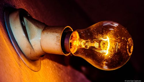 High Contrast, Low exposure shot of glowing Incandescent Light Bulb