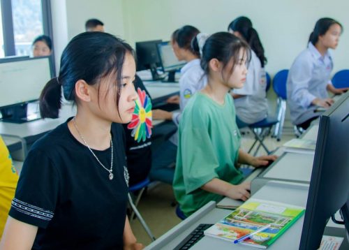 Girls sitting in front of the computers in the classroom