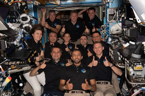 The 11-member crew aboard the International Space Station give thumbs up signs in this portrait. In the bottom row from left are Flight Engineers Andrey Fedyaev of Roscosmos, Sultan Alneyadi from UAE (United Arab Emirates), and Woody Hoburg from NASA. In the middle row from left are Flight Engineers Anna Kikina from Roscosmos, Koichi Wakata from JAXA (Japan Aerospace Exploration Agency), Nicole Mann from NASA, Dmitri Petelin from Roscosmos, and Frank Rubio from NASA. In the back are Flight Engineer Stephen Bowen from NASA, Commander Sergey Prokopyev from Roscosmos, and Flight Engineer Josh Cassada from NASA.