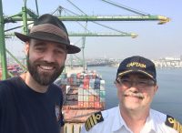 Thor Pedersen standing with the captain on a containership in Jakarta, Indonesia.