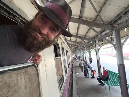 Thor Pedersen looking out the window of a train in Tanzania.