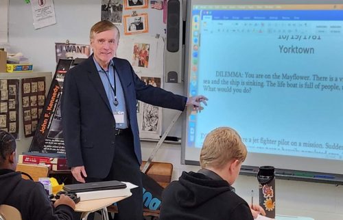 Paul Durietz teaching a class in front of an electronic whiteboard.