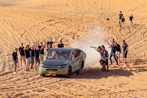 Solar Team Eindhoven is happy to reach the Sahara after their 1,000-kilometer test run. Students celebrate as the solar car drives in the desert.