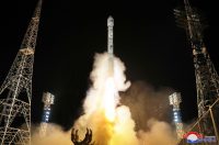 An image showing a rocket launching the North Korean spy satellite Malligyong-1 into space at night.