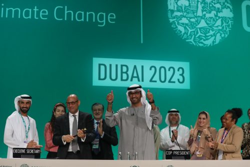 COP28 president, Sultan Al Jaber, and others celebrate after deal is reached.