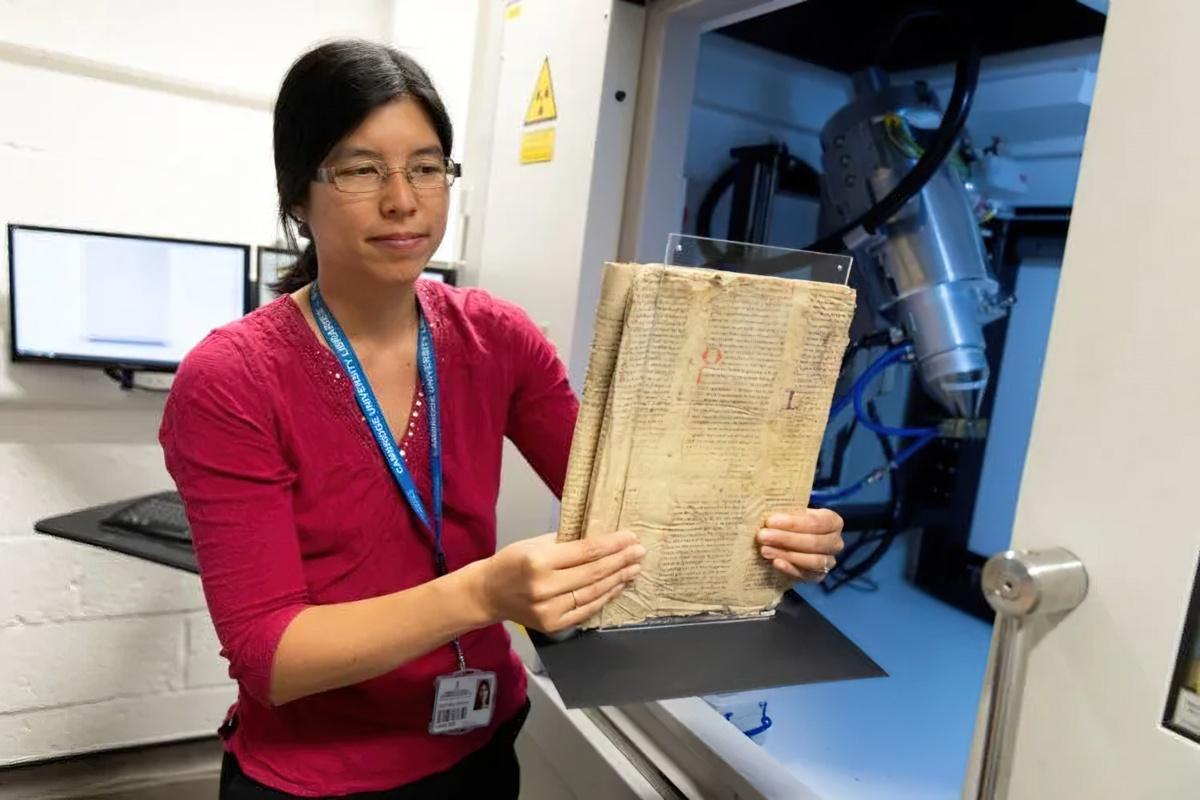 Dr Irène Fabry-Tehranchi holding the rare manuscript before inserting it into the Micro CT scanner in the Department of Zoology.