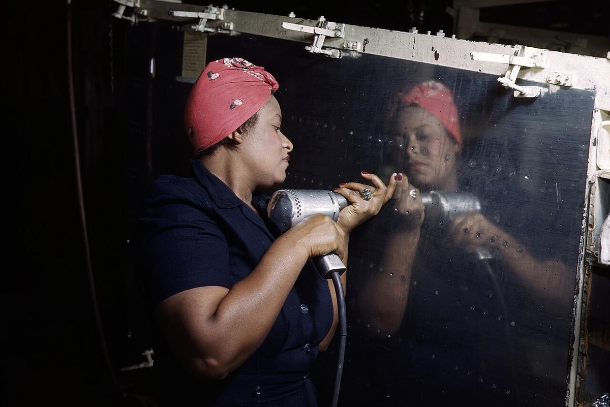 A real-life "Rosie the Riveter" operating a hand drill at Vultee-Nashville, Tennessee, working on an A-31 Vengeance dive bomber 1943.