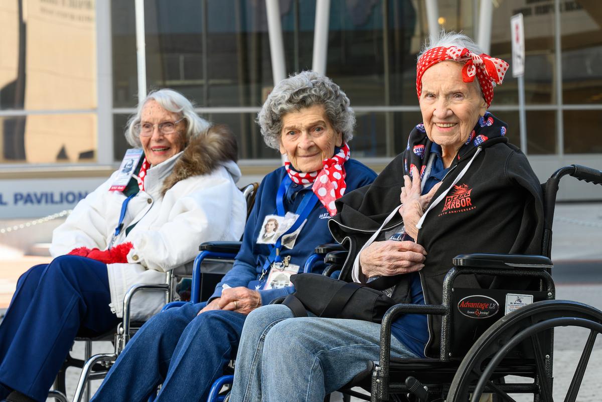Real-life Rosies pose outside the National WWII Museum.