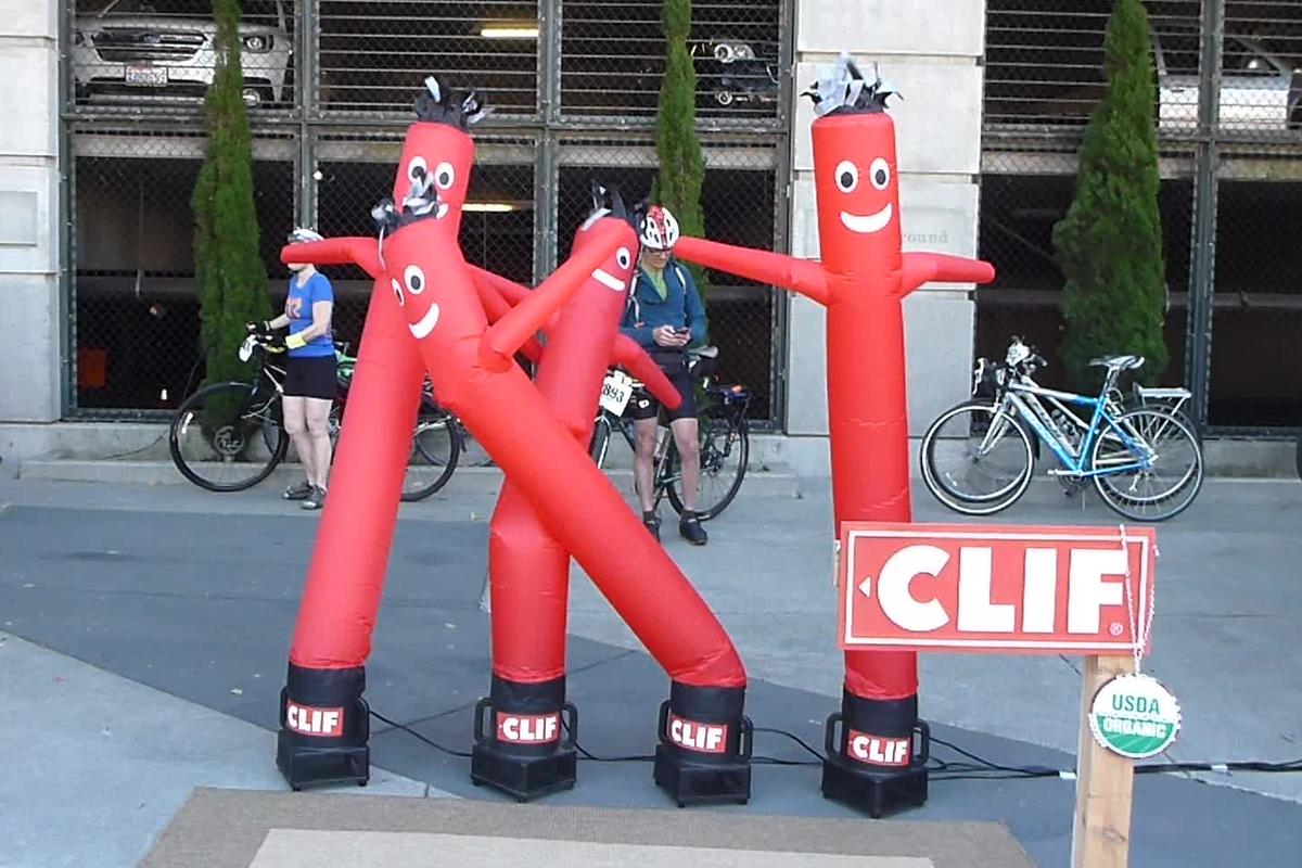 Four red "tube dancers" are seen in different stages of inflation.