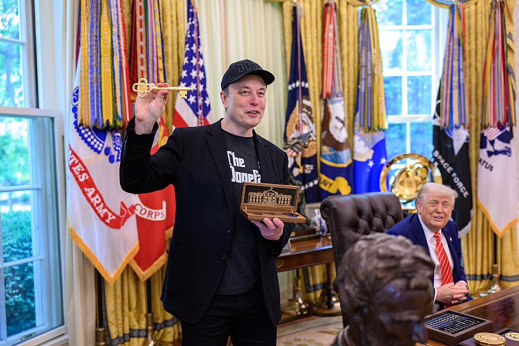 President Donald Trump participates in a press conference with departing DOGE adviser Elon Musk, Friday, May 30, 2025, in the Oval Office. Musk displays the golden key given to him by Mr. Trump while Trump looks on from the background.