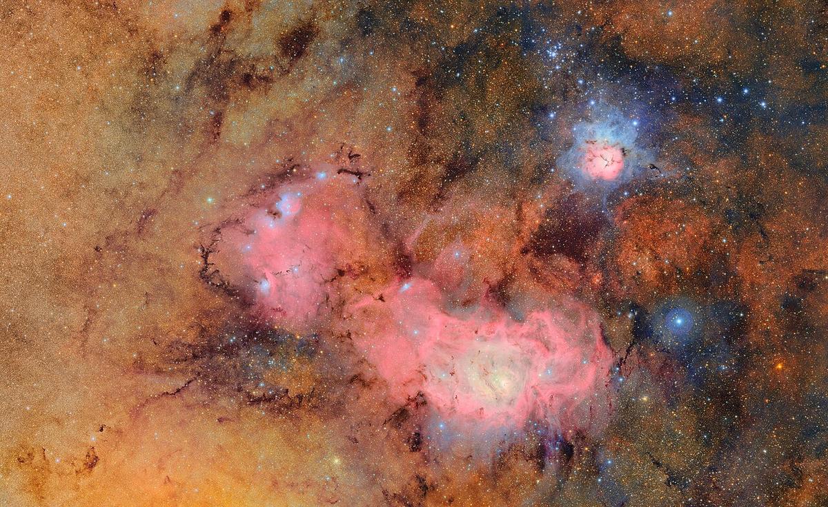 This image combines 678 separate images taken by NSF–DOE Vera C. Rubin Observatory in just over seven hours of observing time. Combining many images in this way clearly reveals otherwise faint or invisible details, such as the clouds of gas and dust that comprise the Trifid nebula (top) and the Lagoon nebula, which are several thousand light-years away from Earth.