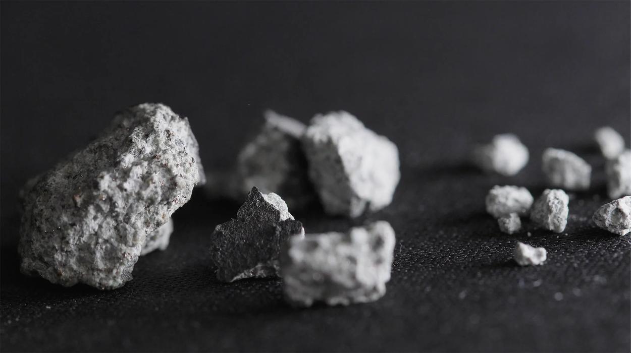 The McDonough Meteorite is likely over 4.56 billion years old. Fragments of the meteorite are seen on a dark material.