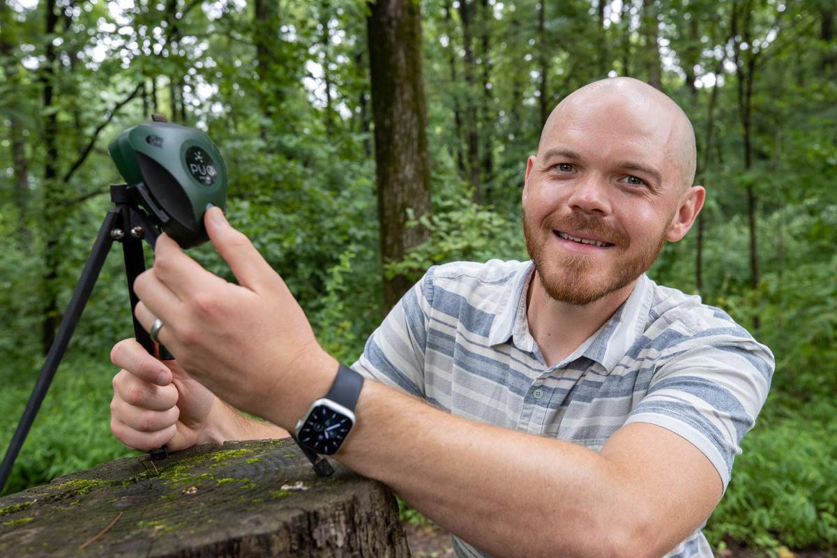 Brent Pease, assistant professor in SIU Carbondale’s School of Forestry and Horticulture, displays a BirdWeather PUC, a weatherproof device with microphones, Wi-Fi, GPS, environmental sensors and AI.