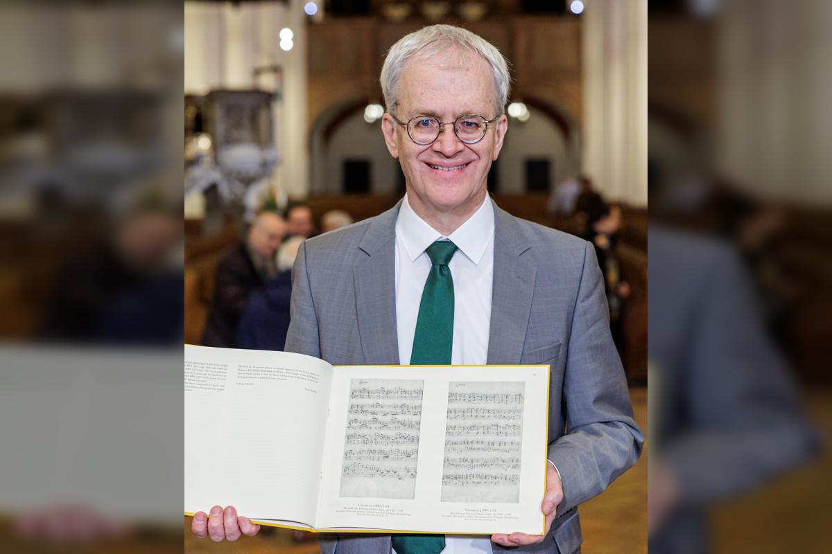 Peter Wollny is shown holding the the music for the two chaconnes written by Johann Sebastian Bach.