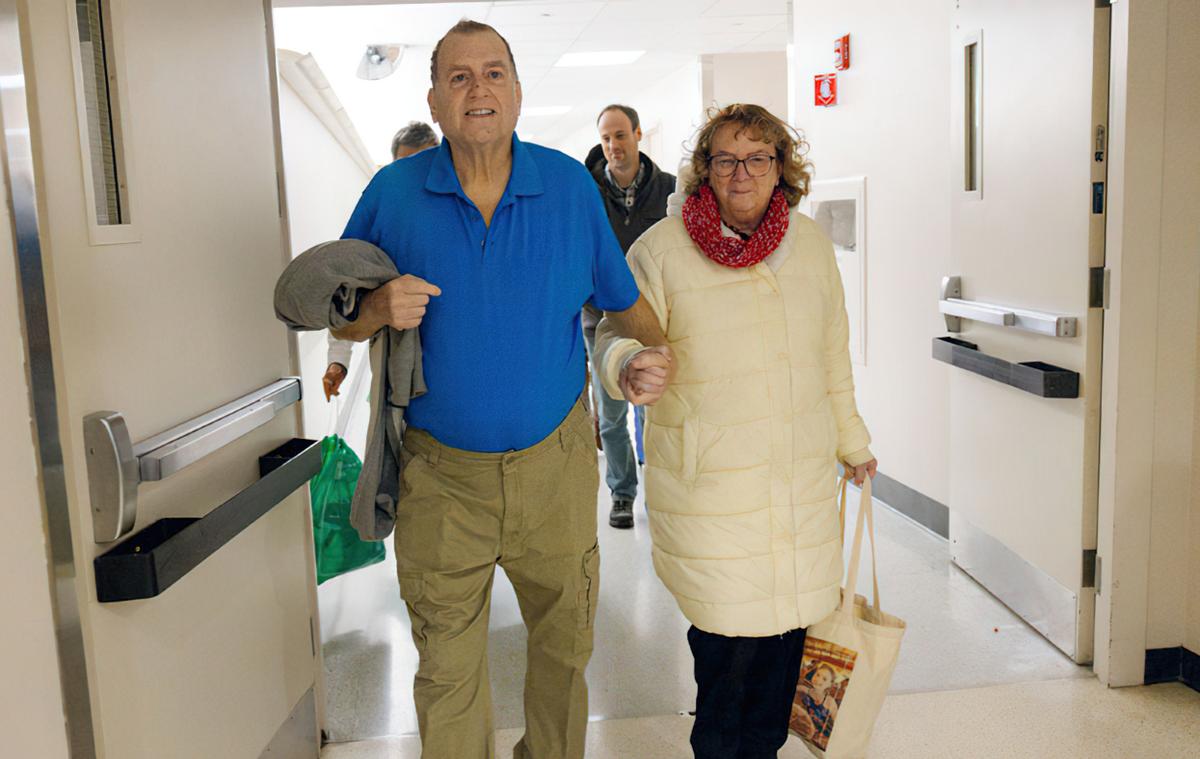 Tim Andrews and his wife leave the hospital after he received the pig kidney transplant about nine months ago.