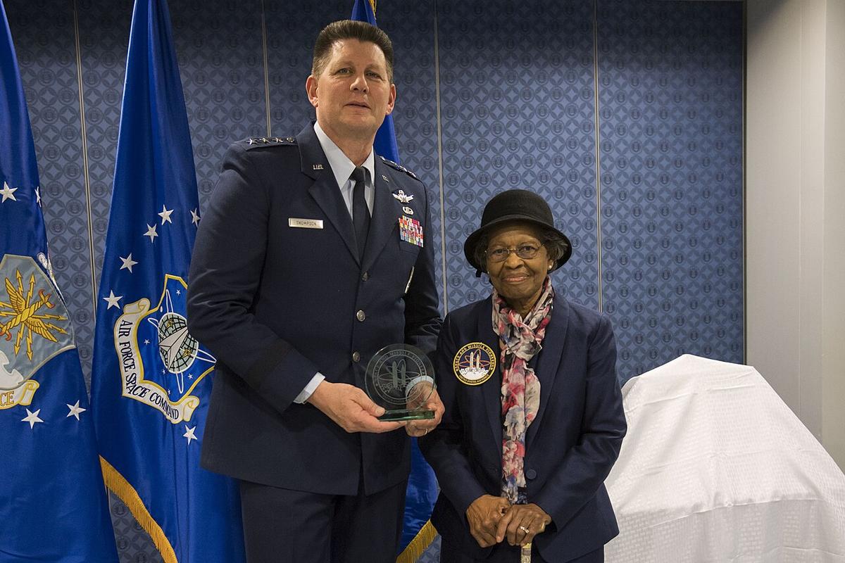 Air Force Space Command Vice Commander Lt. Gen. DT Thompson delivers presents Dr. Gladys West with an award as she is inducted into the Air Force Space and Missile Pioneers Hall of Fame during a ceremony in her honor at the Pentagon in Washington, D.C., Dec. 6, 2018.