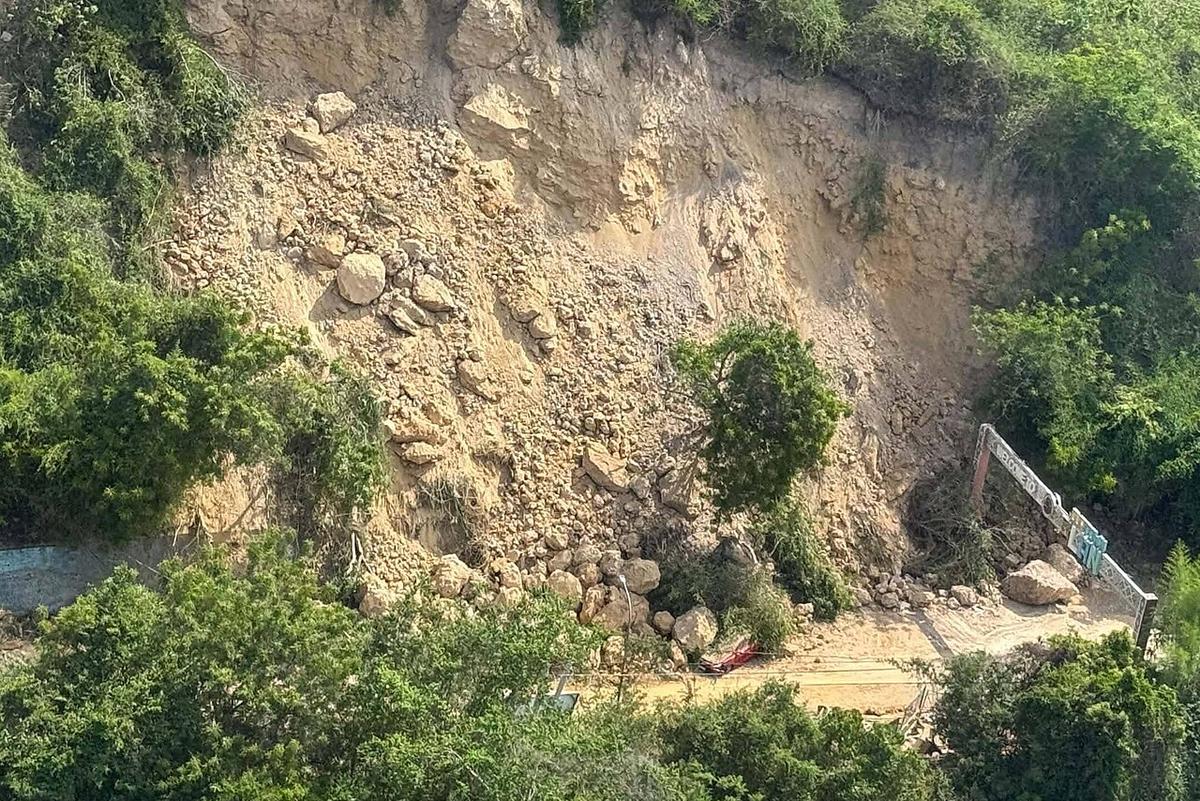Aerial view of a landslide-affected area in Sarangani during the RDANA mission following the magnitude 7.8 earthquake on June 8, 2026. Aerial view of a massive landslide covering a road and hillside in Sarangani, featuring large rocks and debris scattered across the terrain, partially closing a road.