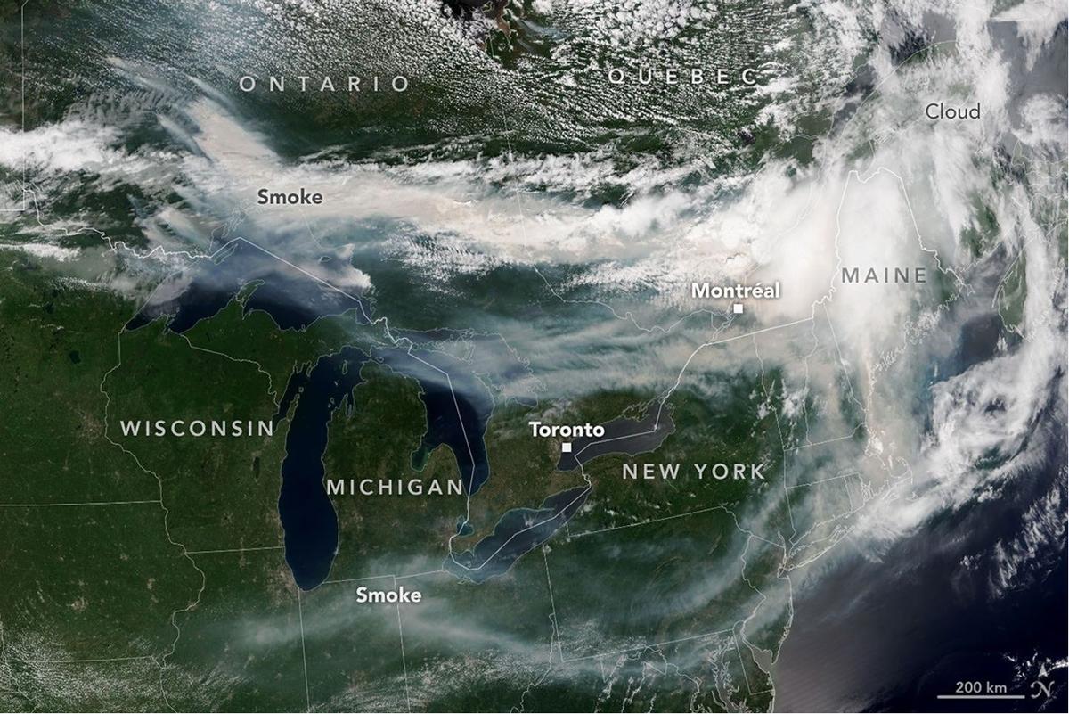 Smoke from wildland fires pours eastward over Canada and the U.S. in an image captured on the afternoon of July 14, 2026, by the VIIRS (Visible Infrared Imaging Radiometer Suite) on the NOAA-21 satellite.